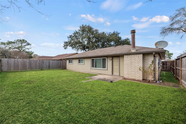 back of house featuring a lawn and a patio