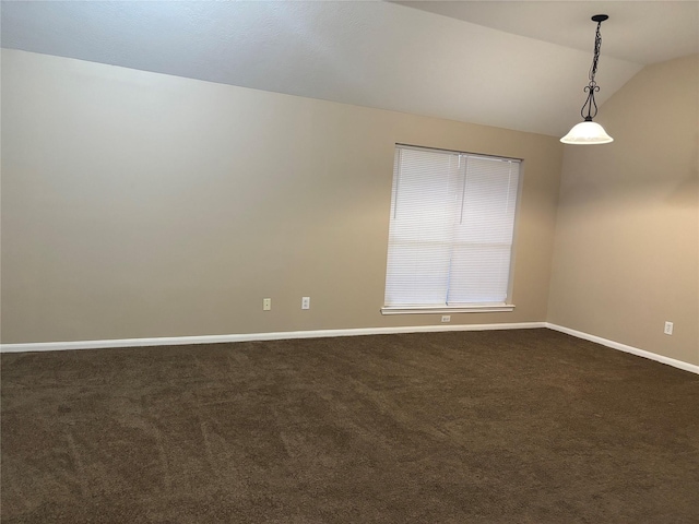 spare room featuring lofted ceiling and carpet