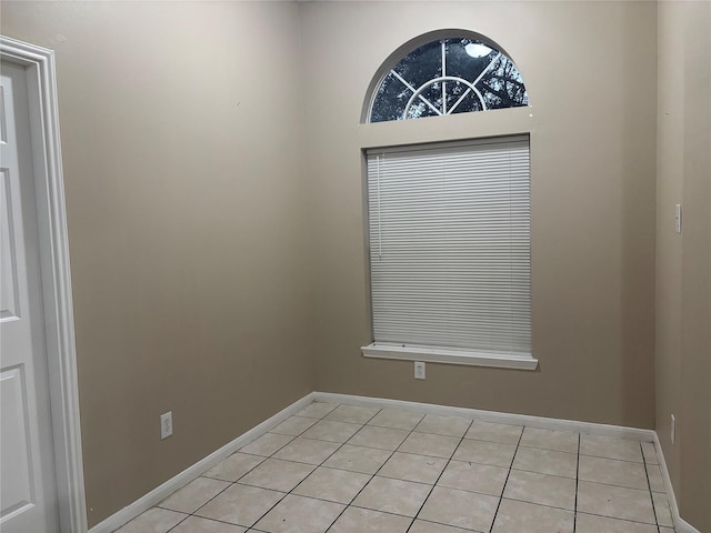 unfurnished room featuring light tile patterned floors