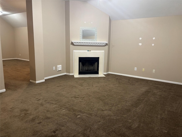 unfurnished living room with lofted ceiling and dark colored carpet