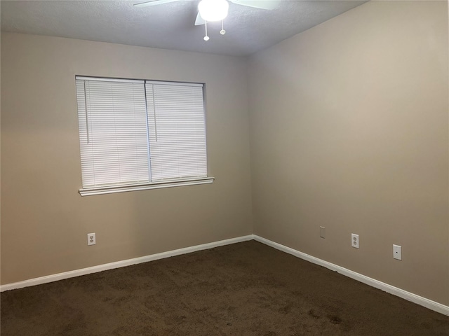 unfurnished room featuring ceiling fan and dark colored carpet