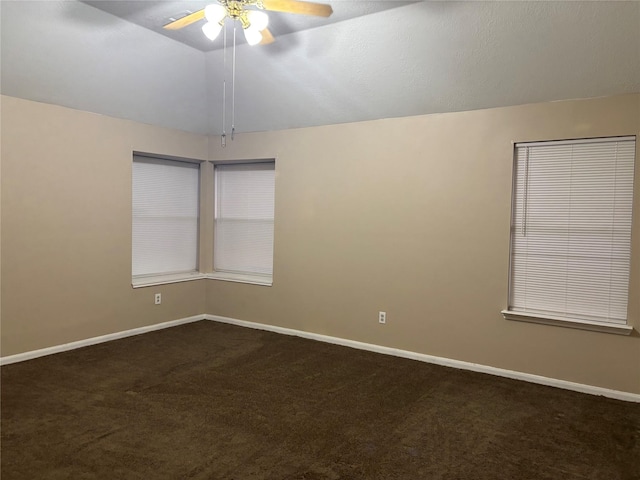 carpeted spare room featuring lofted ceiling and ceiling fan