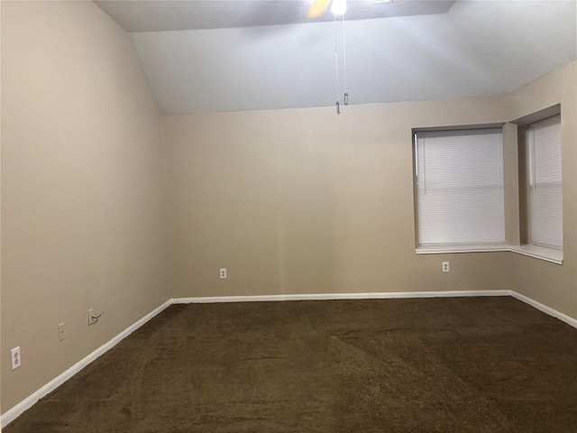 carpeted spare room featuring lofted ceiling