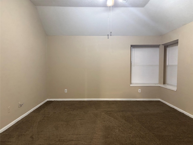 unfurnished room with vaulted ceiling and carpet flooring