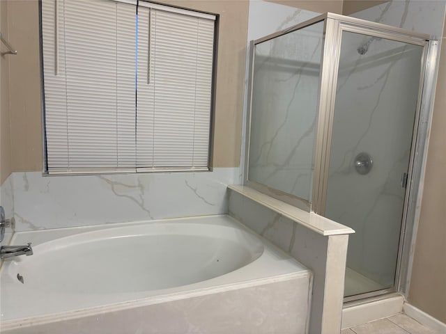 bathroom with tile patterned floors and plus walk in shower