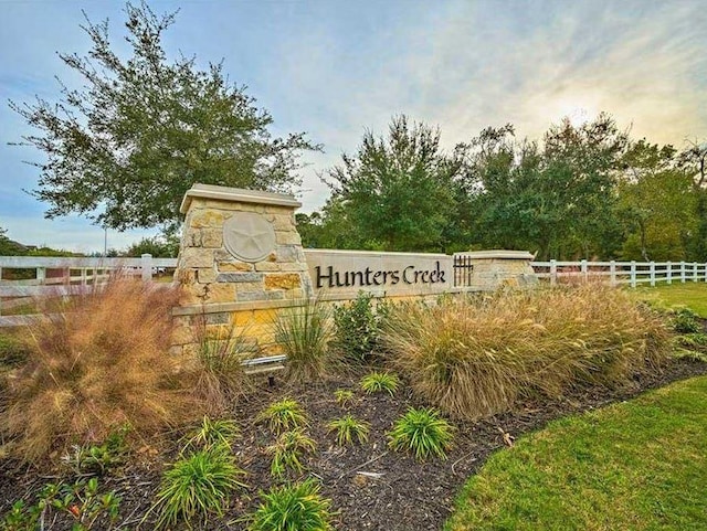 community sign with fence