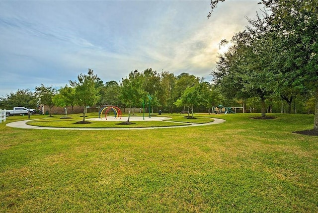 view of community with playground community and a yard