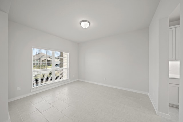 unfurnished room featuring baseboards