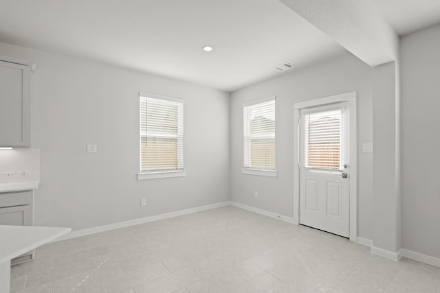 unfurnished dining area featuring visible vents, recessed lighting, and baseboards