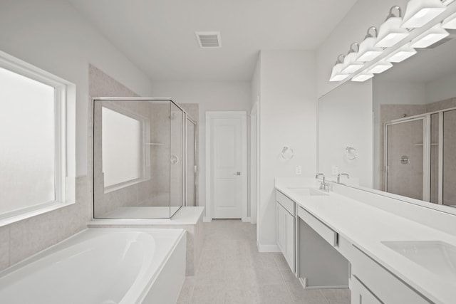 full bathroom featuring visible vents, a shower stall, double vanity, a bath, and a sink