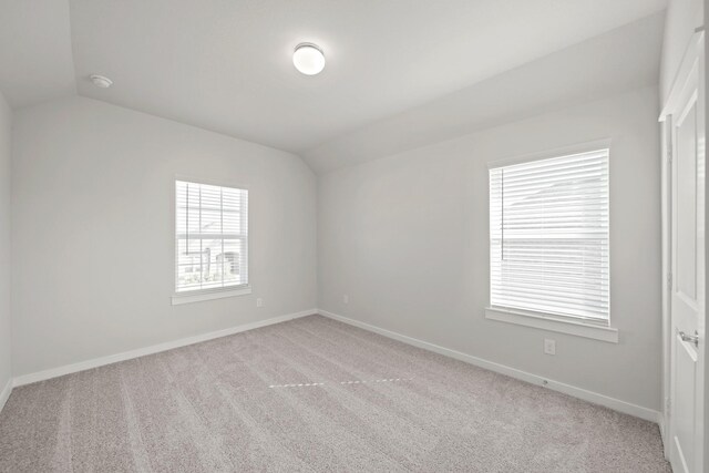 unfurnished room with baseboards, carpet floors, and vaulted ceiling