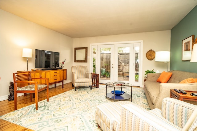 living room with hardwood / wood-style floors and french doors