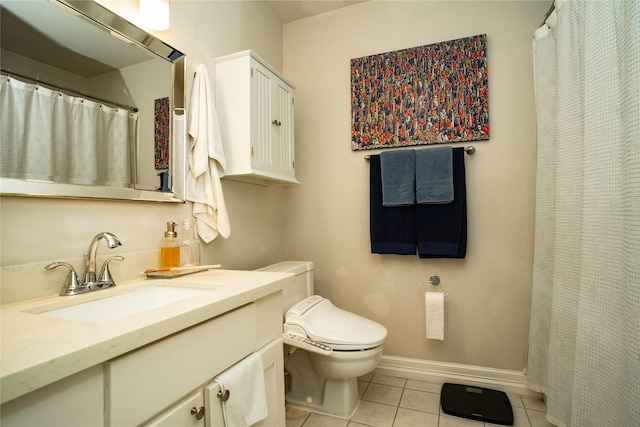 bathroom with tile patterned flooring, vanity, and toilet