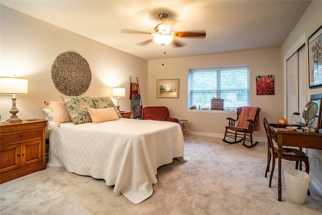 carpeted bedroom featuring ceiling fan and a closet