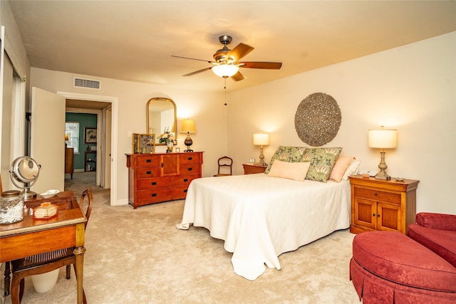 bedroom featuring light carpet and ceiling fan