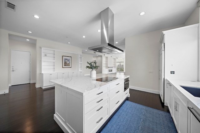 kitchen with light stone countertops, white cabinetry, a kitchen island, and island range hood