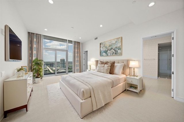 bedroom featuring access to exterior, a wall of windows, and light colored carpet