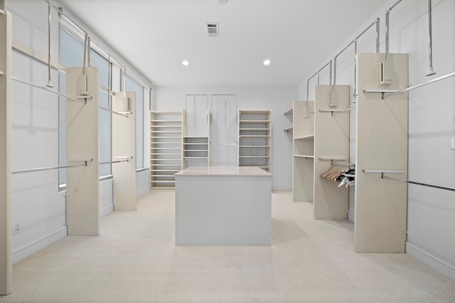 walk in closet featuring light carpet