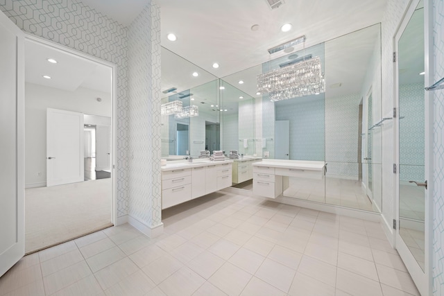 bathroom featuring tile patterned floors, vanity, and a shower with shower door