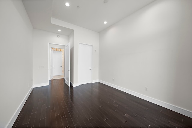 unfurnished room featuring dark hardwood / wood-style floors