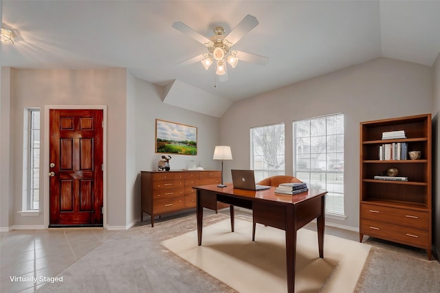 tiled home office featuring ceiling fan and vaulted ceiling