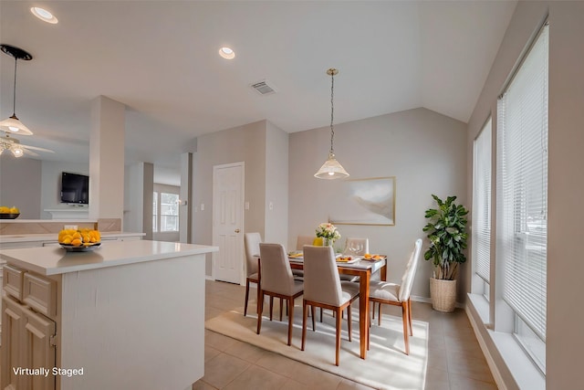 dining space with light tile patterned flooring, ceiling fan, and lofted ceiling