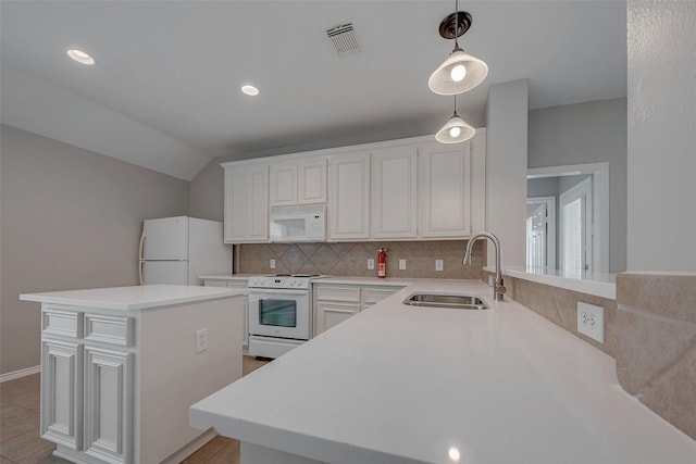 kitchen with a kitchen island, pendant lighting, sink, white cabinets, and white appliances