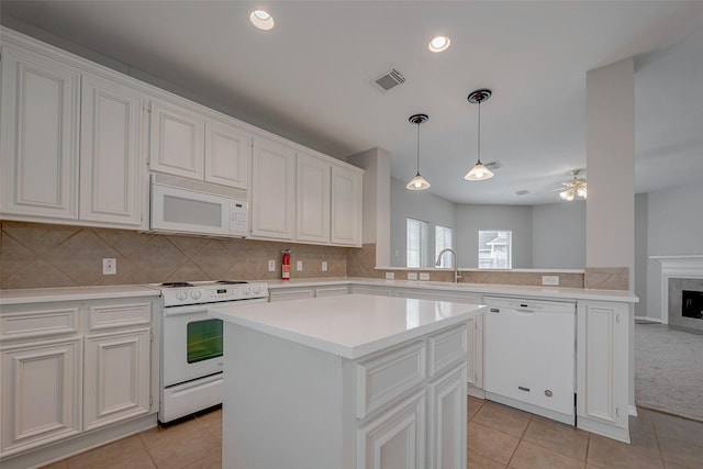 kitchen with white cabinetry, white appliances, and a center island