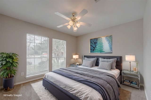 bedroom featuring ceiling fan and light carpet