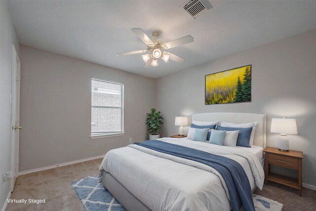 bedroom with ceiling fan and light carpet