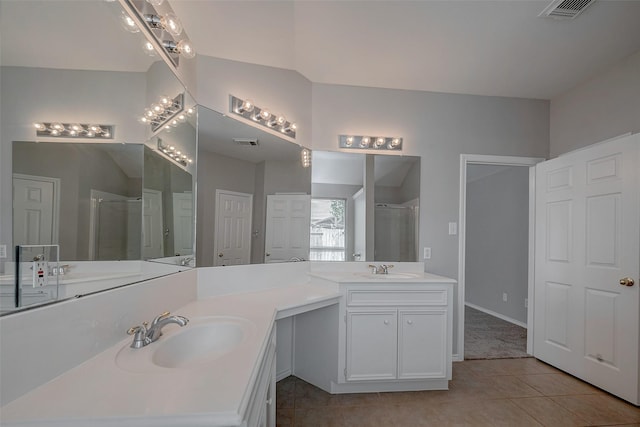 bathroom featuring vanity, tile patterned floors, and walk in shower