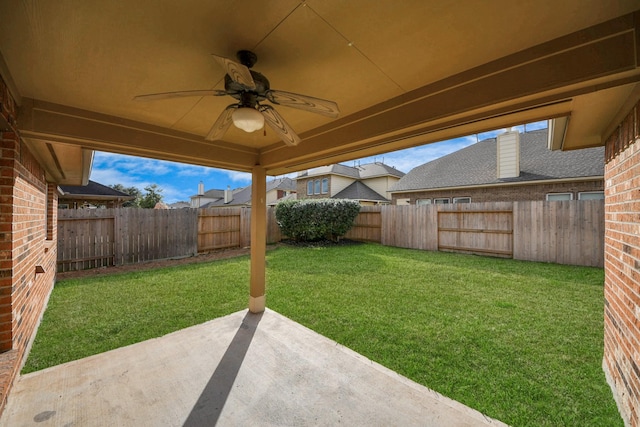 view of yard featuring ceiling fan and a patio area