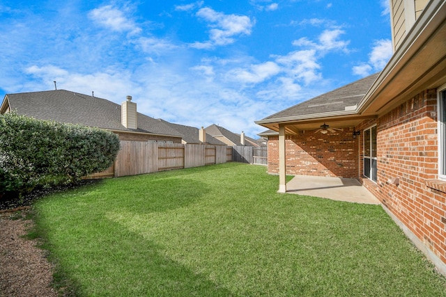 view of yard with ceiling fan and a patio area