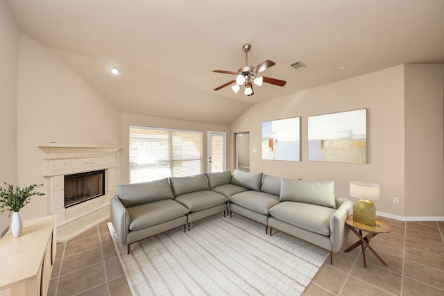 tiled living room featuring ceiling fan and vaulted ceiling