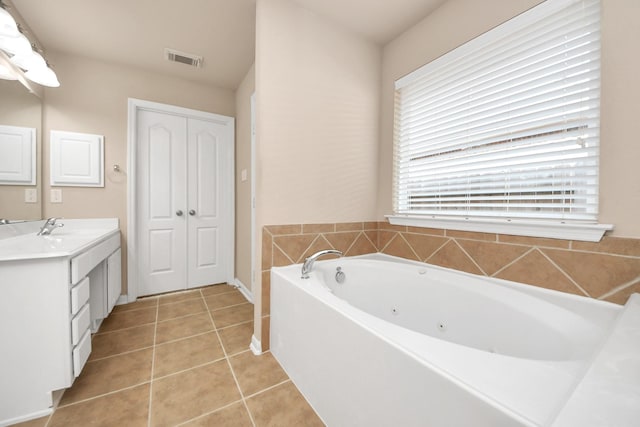 bathroom with vanity, tile patterned flooring, and a tub