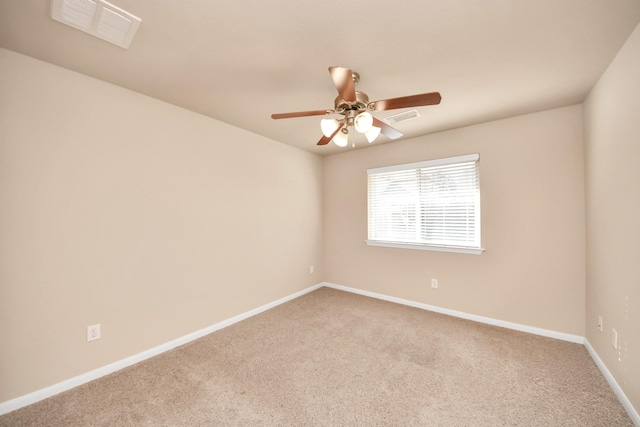 spare room with light colored carpet and ceiling fan