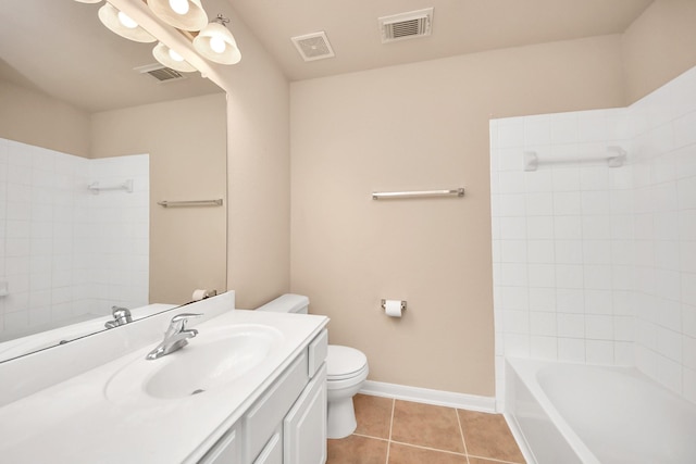 full bathroom with tile patterned flooring, vanity, tiled shower / bath, and toilet