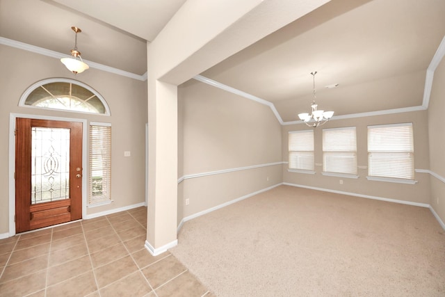 foyer featuring crown molding, vaulted ceiling, and a healthy amount of sunlight