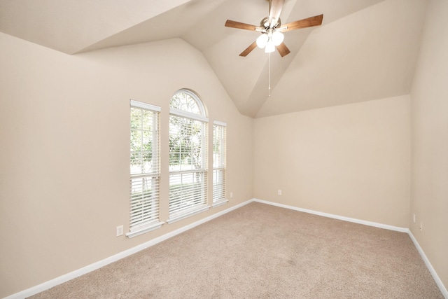 spare room featuring vaulted ceiling, ceiling fan, and carpet floors