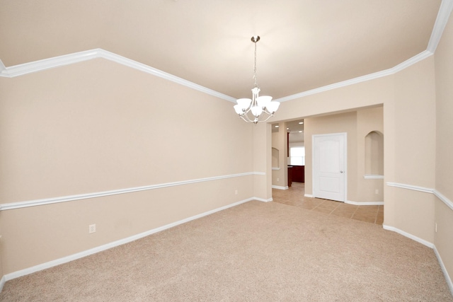 carpeted empty room featuring ornamental molding and a notable chandelier