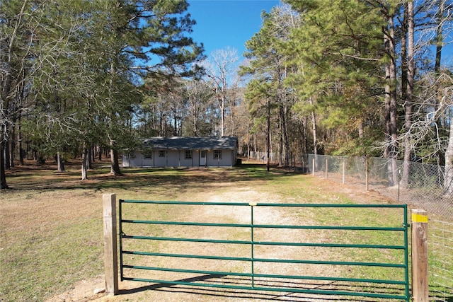 view of gate featuring a yard