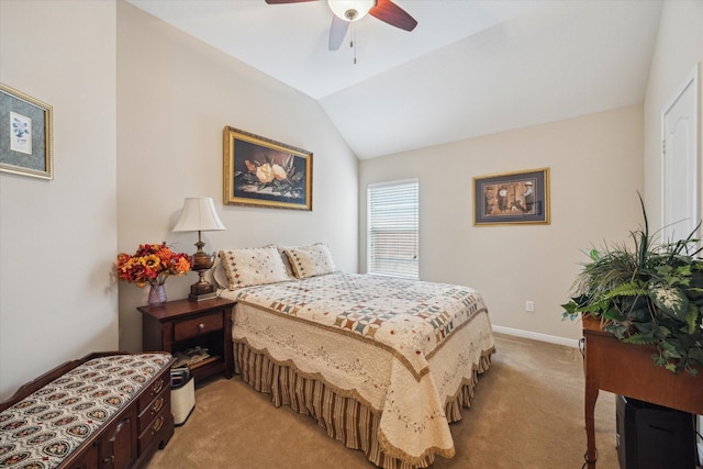 bedroom with vaulted ceiling, light colored carpet, and ceiling fan