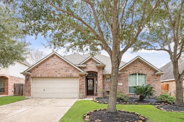 view of front of home featuring a garage and a front lawn