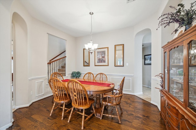 dining area featuring dark hardwood / wood-style flooring and a notable chandelier