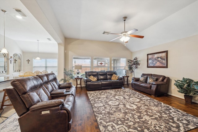 living room featuring dark wood-type flooring, vaulted ceiling, and ceiling fan