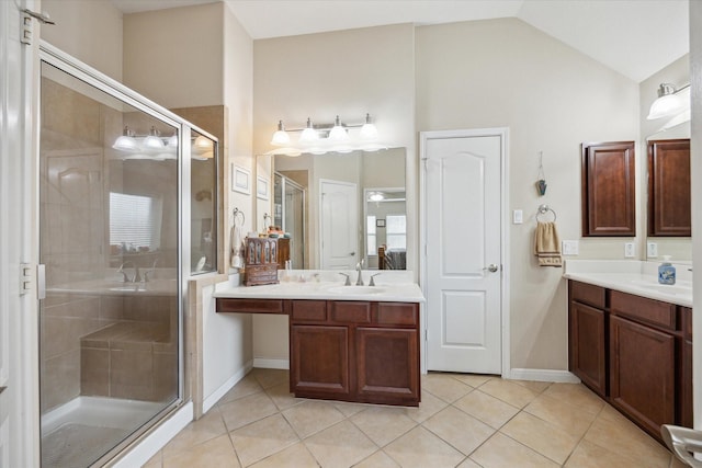 bathroom with walk in shower, lofted ceiling, tile patterned flooring, and vanity