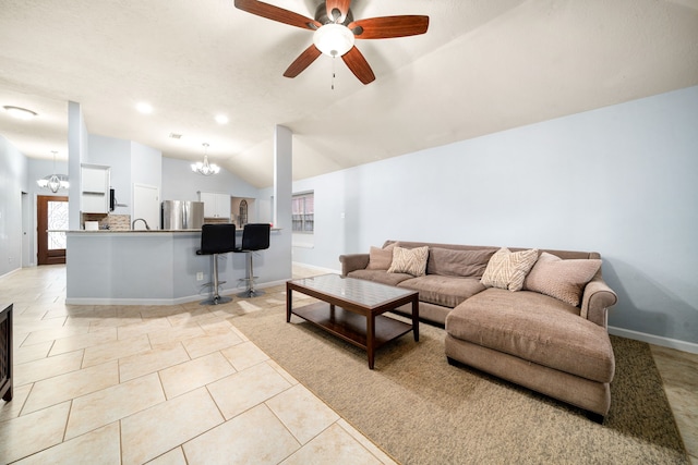 living room with ceiling fan with notable chandelier, sink, vaulted ceiling, and light tile patterned floors