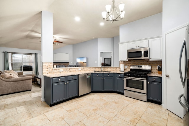 kitchen featuring sink, gray cabinetry, appliances with stainless steel finishes, pendant lighting, and decorative backsplash