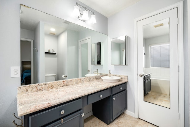 bathroom featuring tile patterned floors, vanity, and toilet