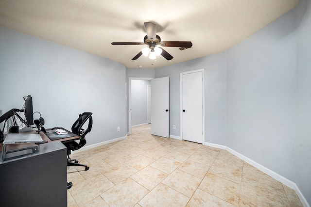 tiled home office featuring ceiling fan